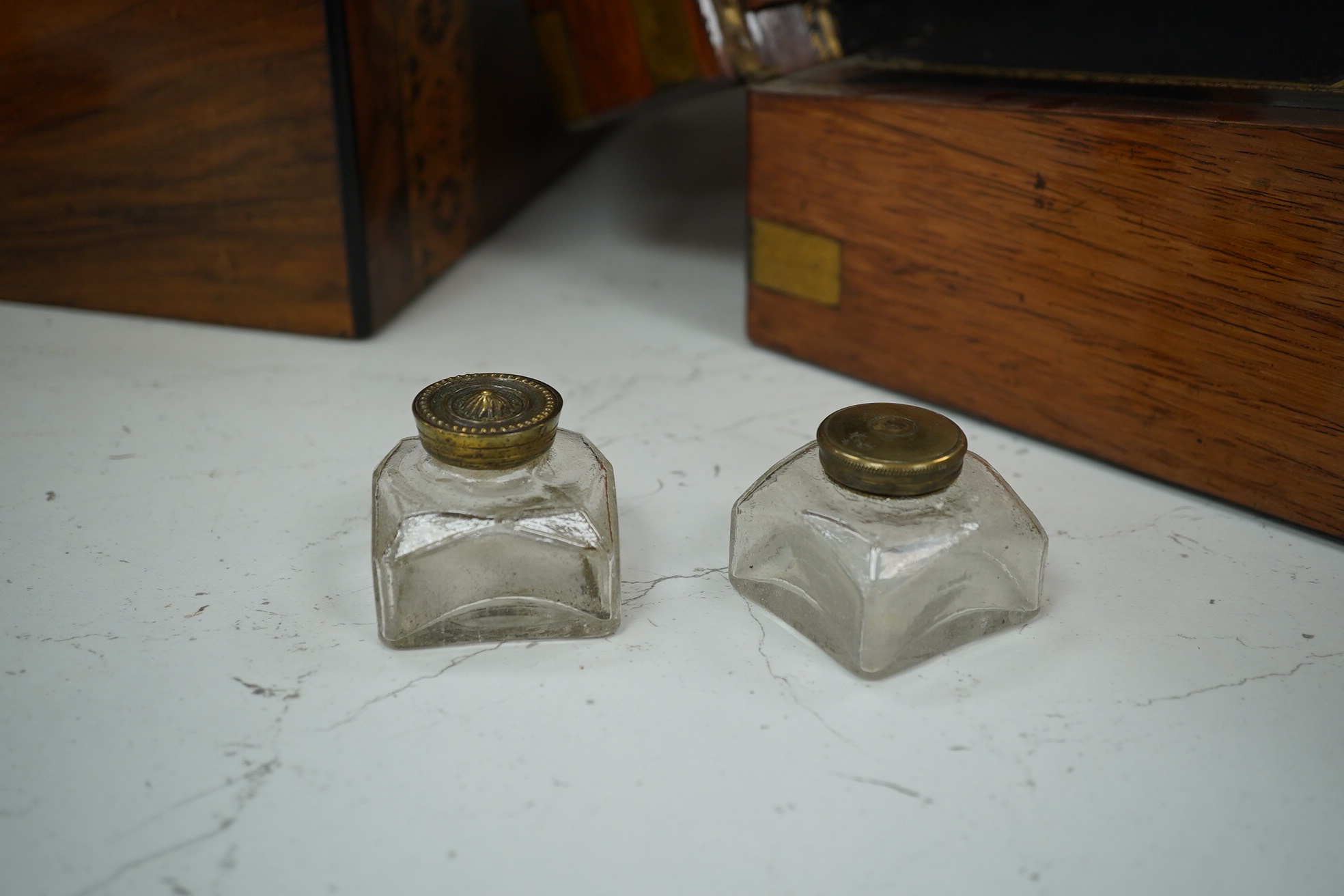 A mahogany brass mounted 19th century writing box and a walnut inlaid and mother of pearl writing box, brass mounted box, 35cm wide. Condition - exterior good, felt on slope torn.